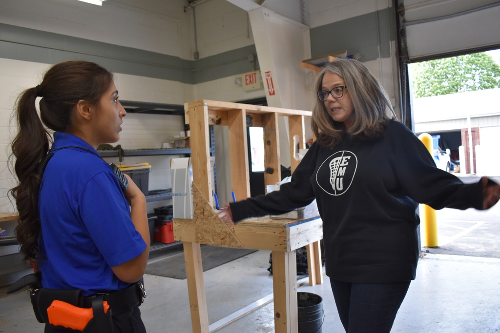 A student keeping a person away from a scene