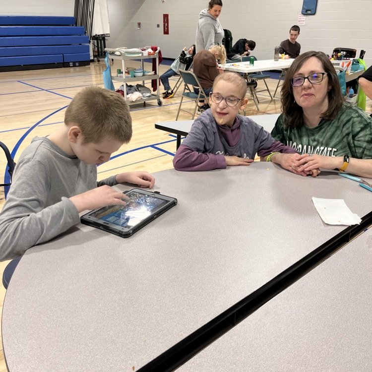 two students and a teacher at lunch 