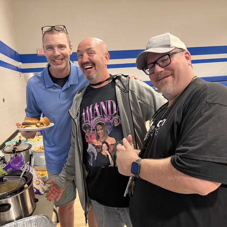 three staff members enjoying the cookout