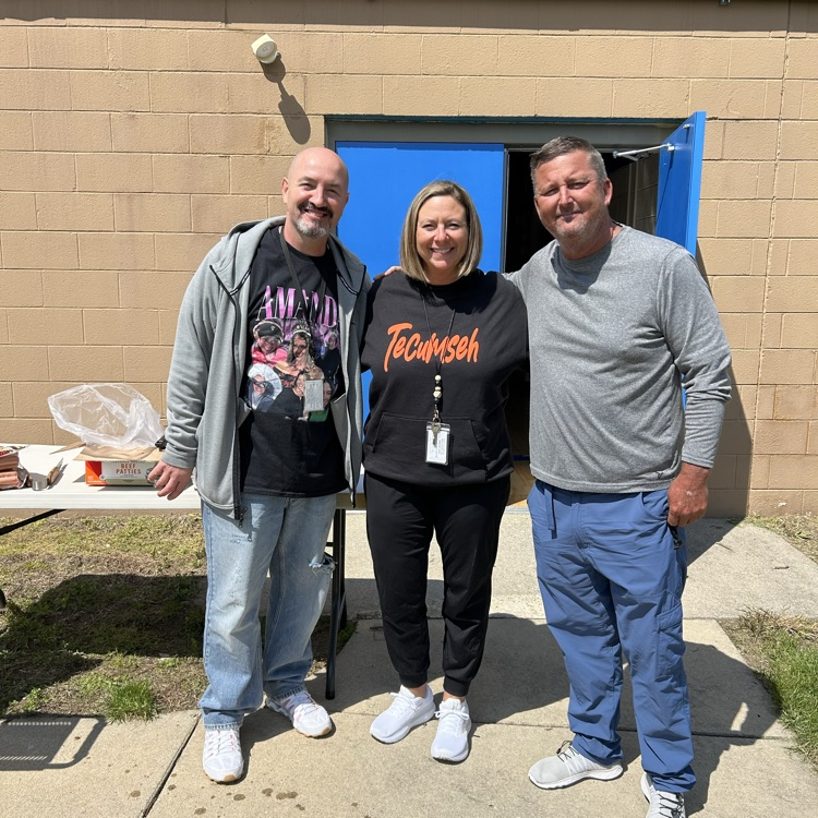 three staff members posing for a photo 