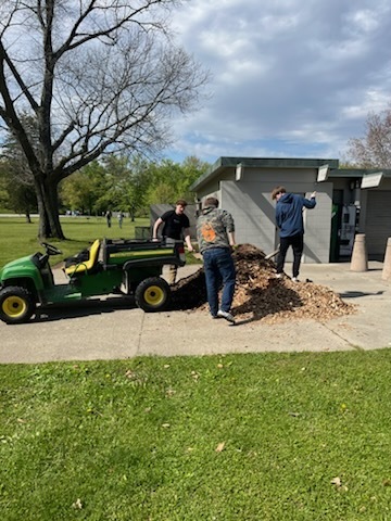 Natural Resources students shoveling mulch to spread in the rain garden.