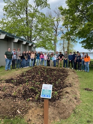 Natural Resources students stand behind their newly planted rain garden at Hayes State Park.