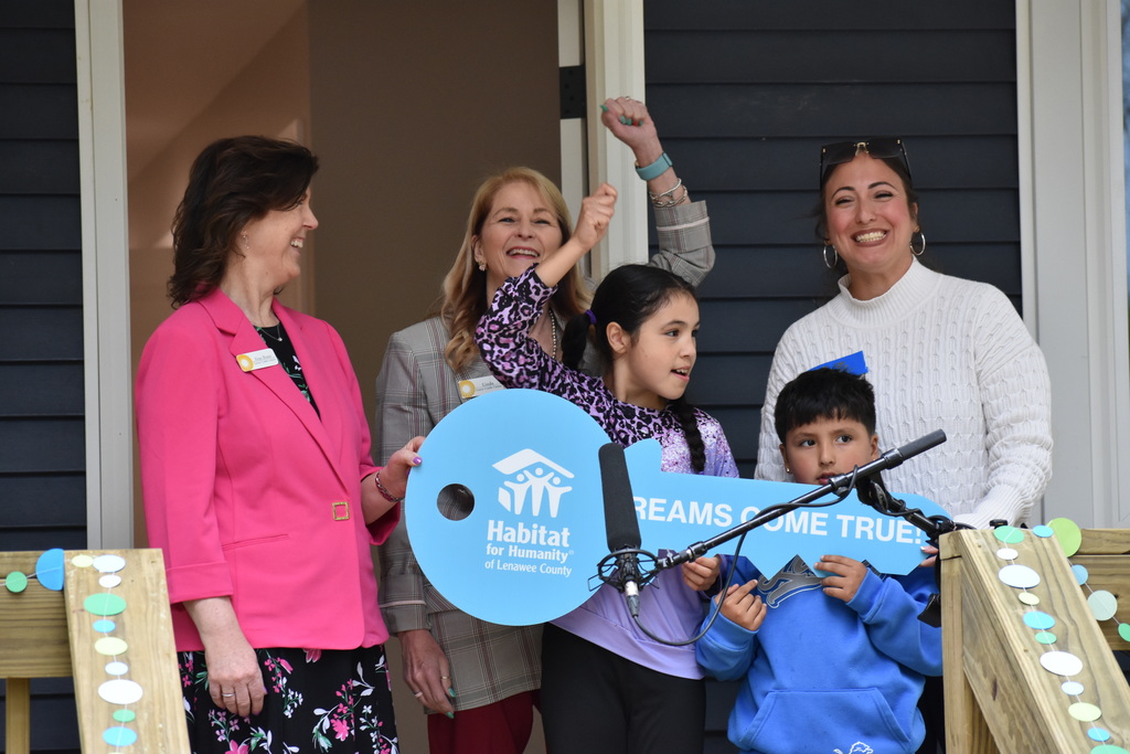 Lenco Credit Union passing a giant key to the family