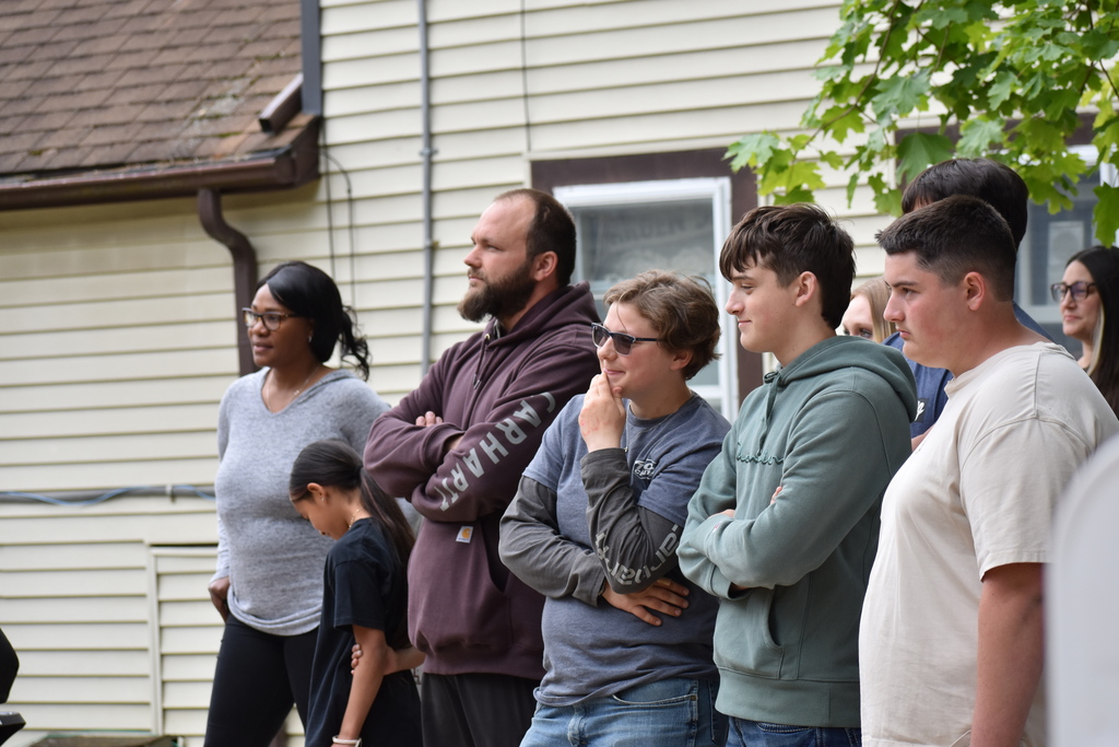 Students and their instructor standing outside the house in the audience