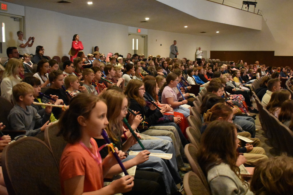 Students playing their recorders in the audience