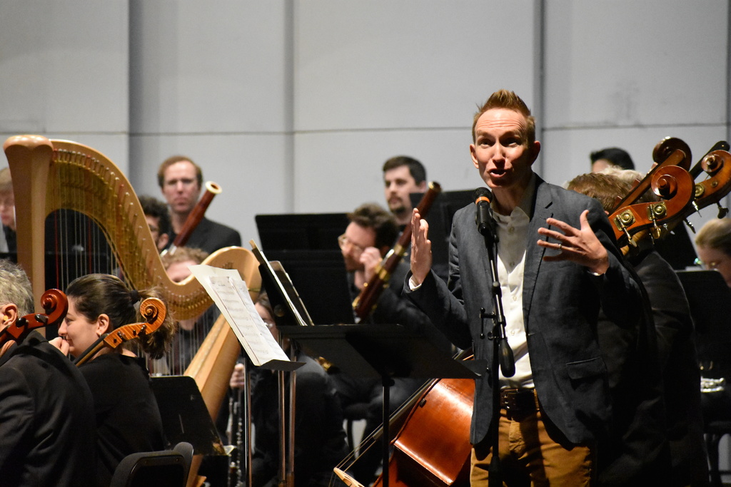 A gentleman from the orchestra engaging the students in the crowd