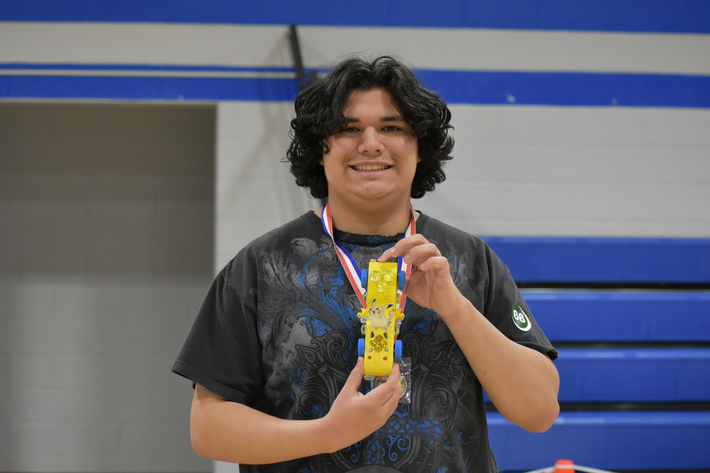Lyrik, the first ever winner of the pinewood derby posing with his winning car