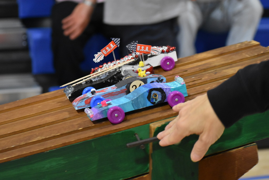 Cars on the start line as someone pushes the lever