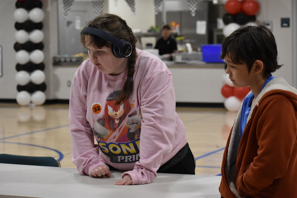 Students watching their cars head toward the finish line