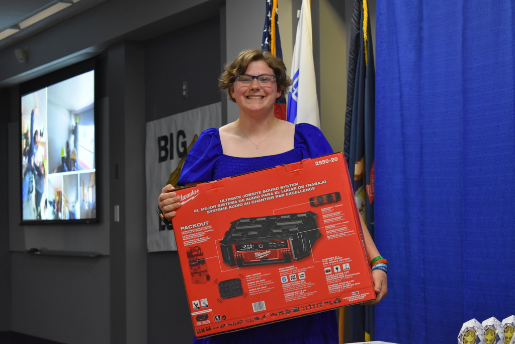 An award winner holding up the prize she won