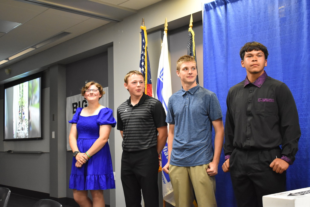 All four candidates standing up front