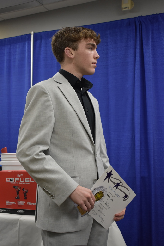A student award winner listening to a speech