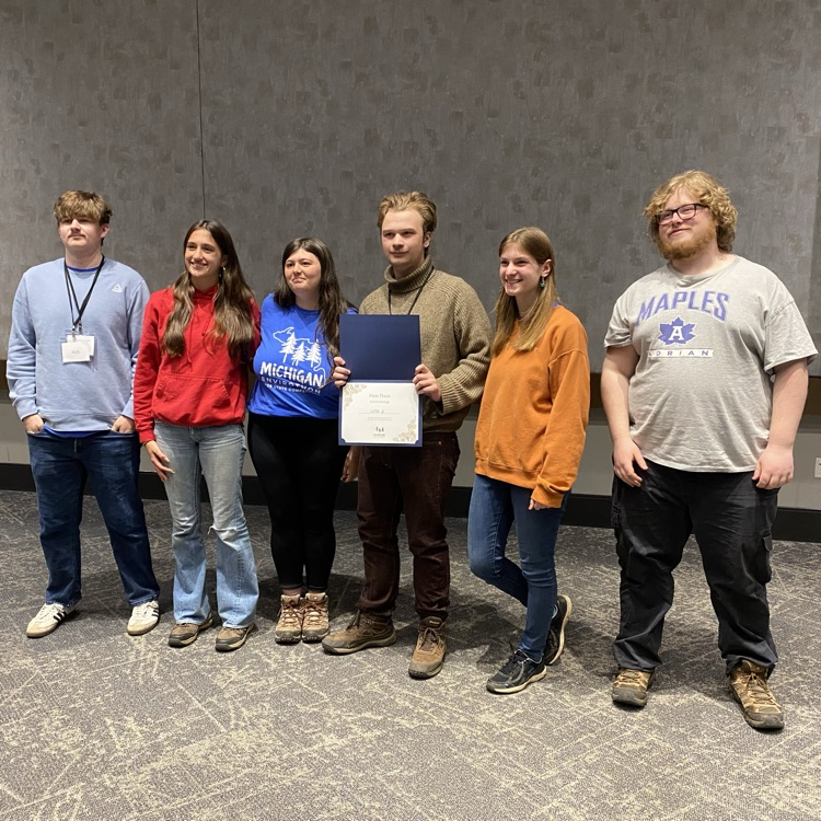 Students posing with award