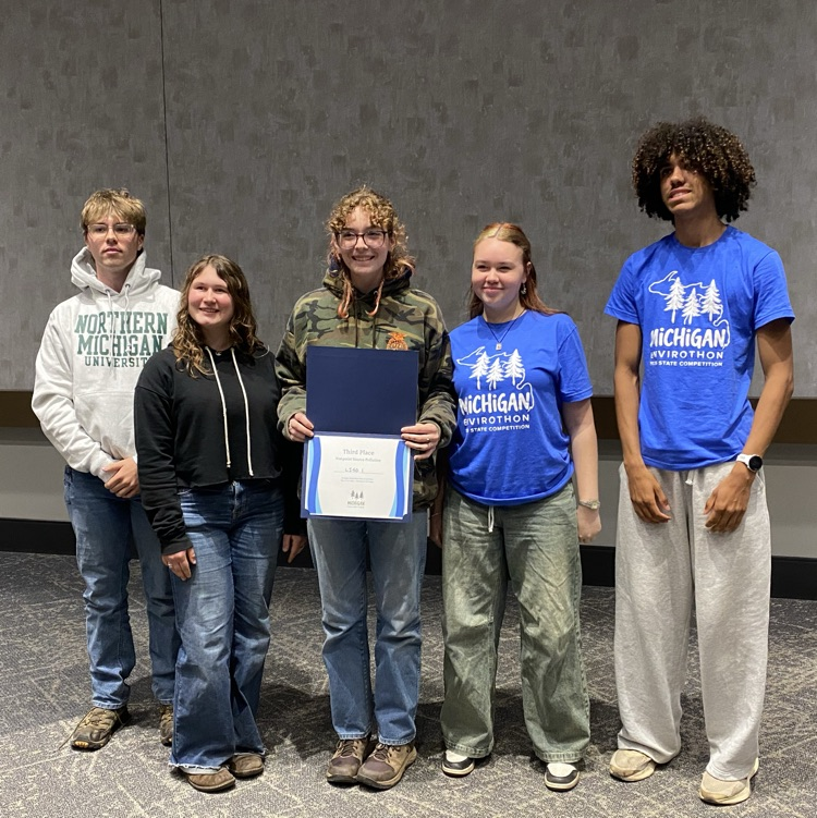 Students posing with award