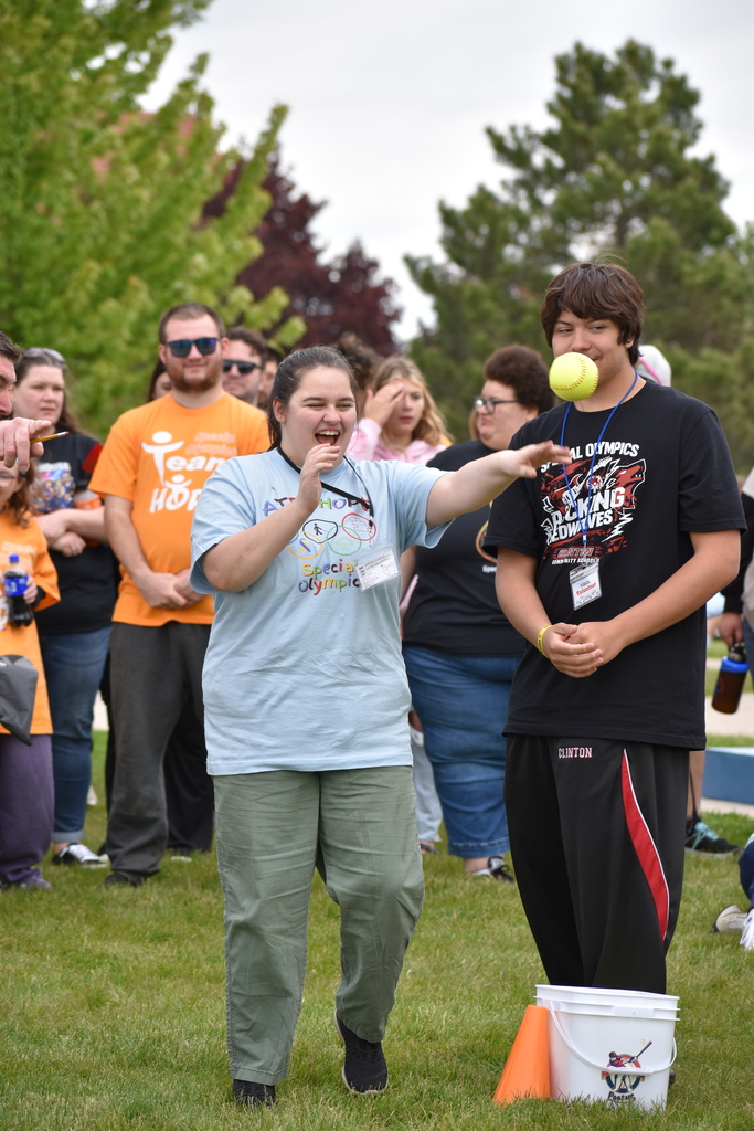 Our student throwing a ball while a crowd looks on