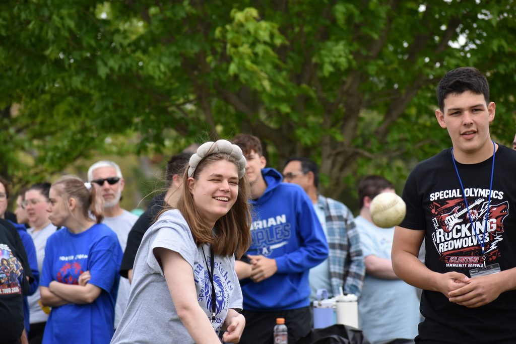 A student throws a ball while others watch