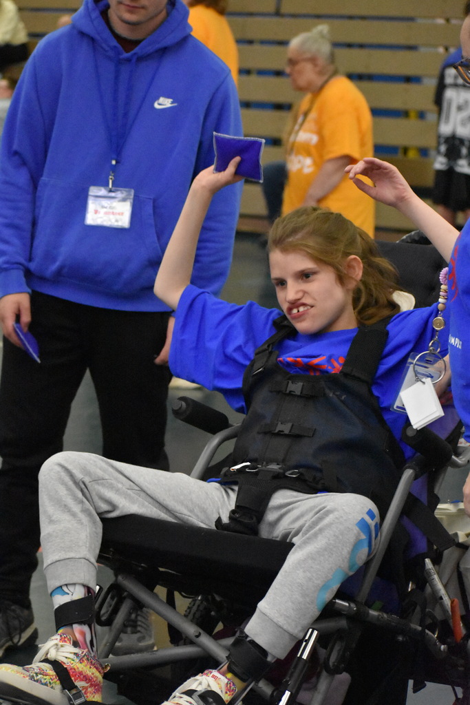 A student tosses a bean bag