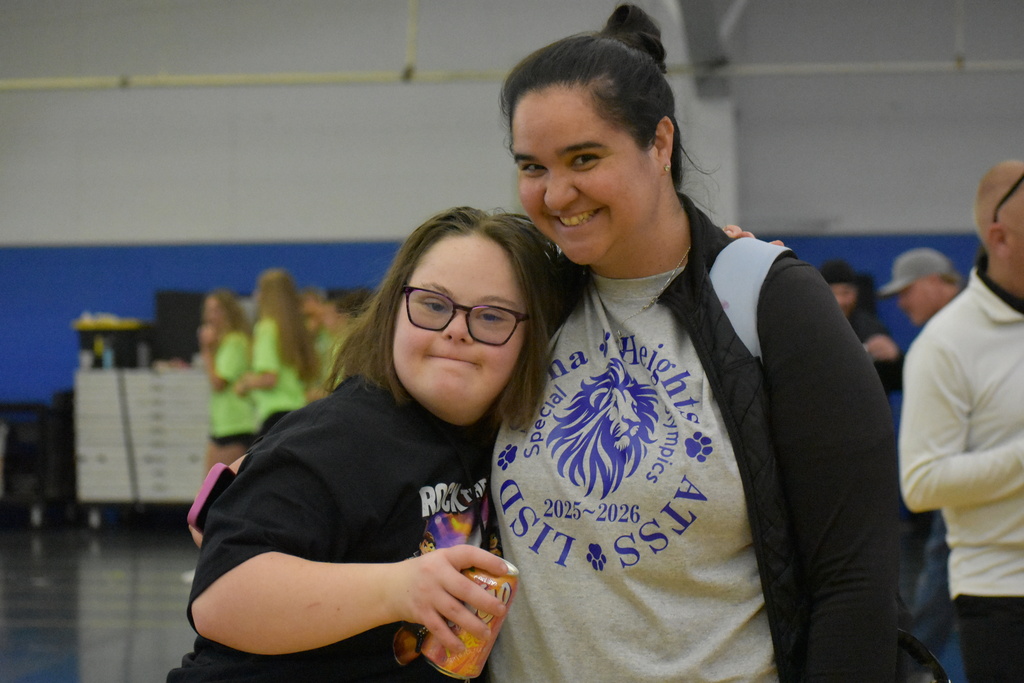 A teacher and student posing for a photo
