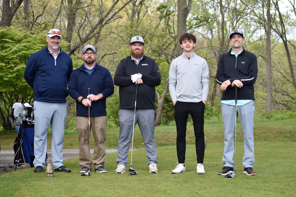 The TECH Center team on the golf course posing for a photo