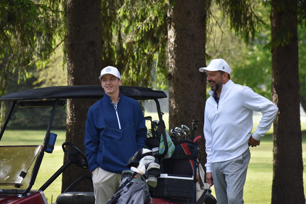 A couple golfers laughing on the course