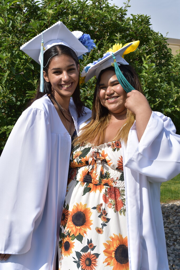 Two graduates posing together