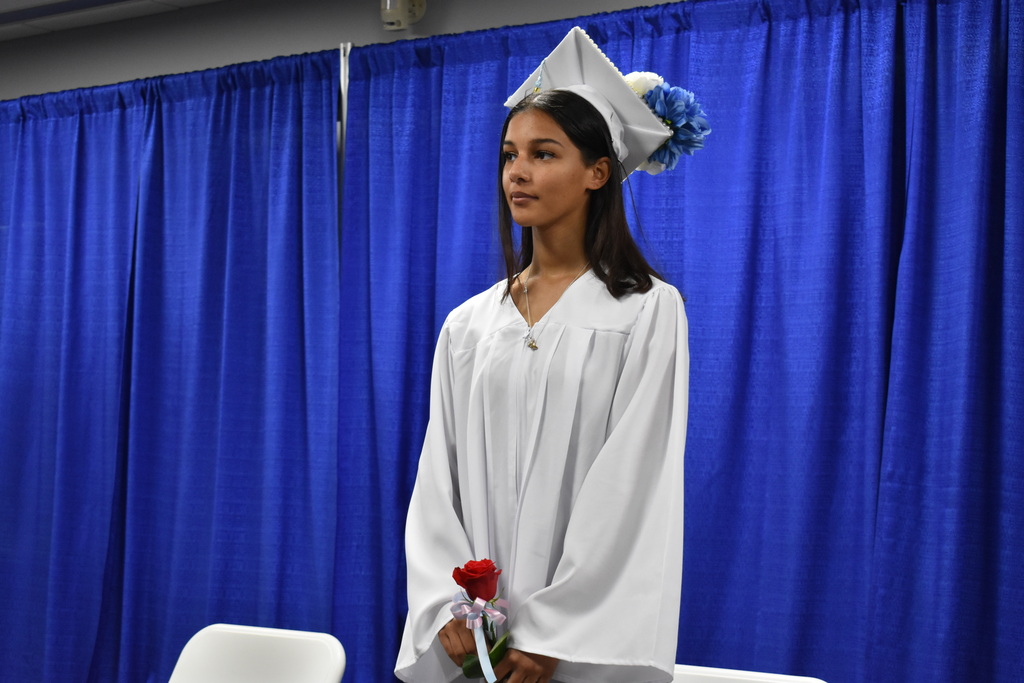 A graduate standing on stage