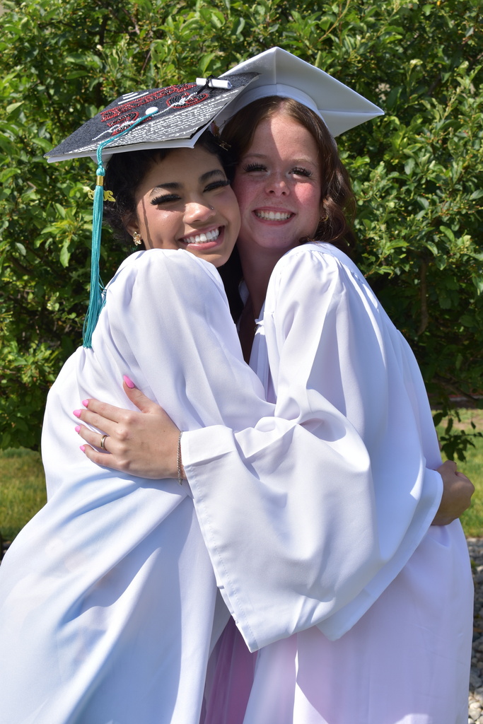 Two graduates posing together