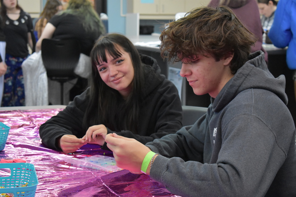 Two students making bracelets