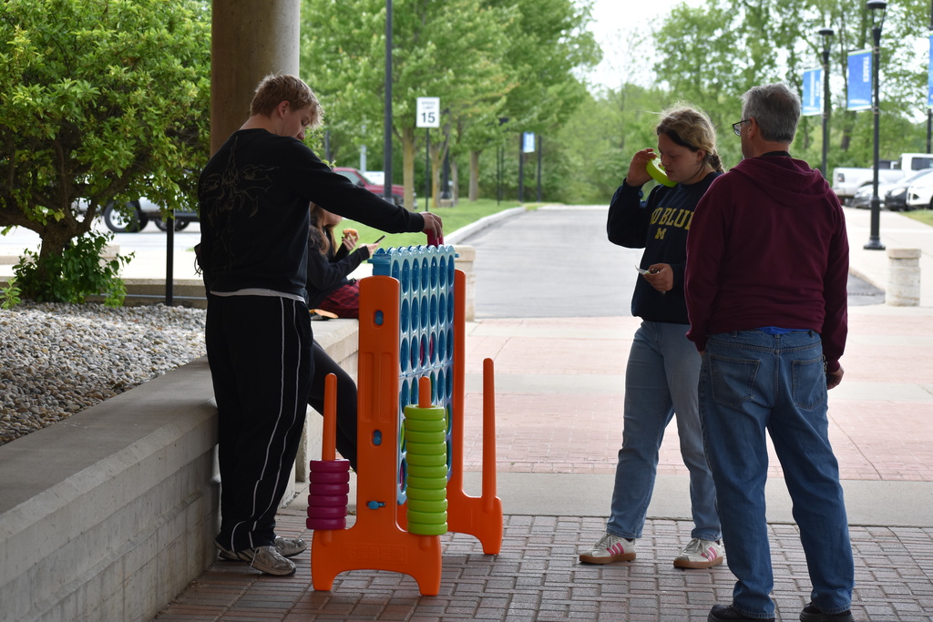 Four people playing giant connect four