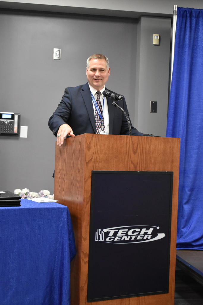 Mark Haag speaking at the podium