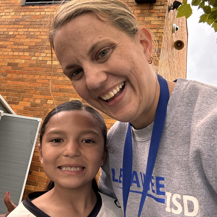 LISD employee with a student smiling in the camera