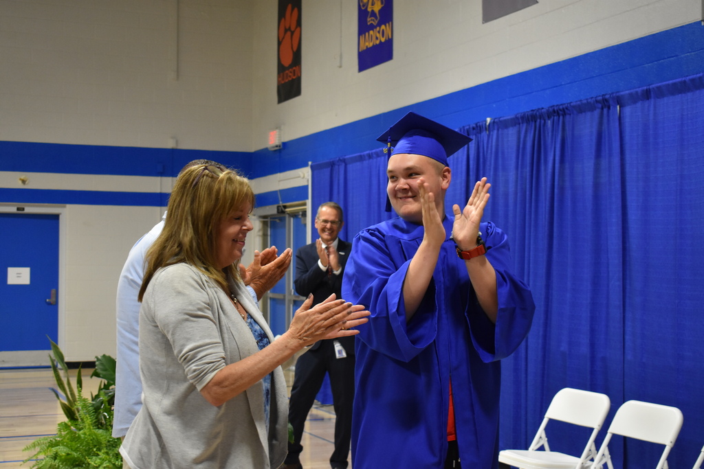 A graduate clapping about receiving his diploma