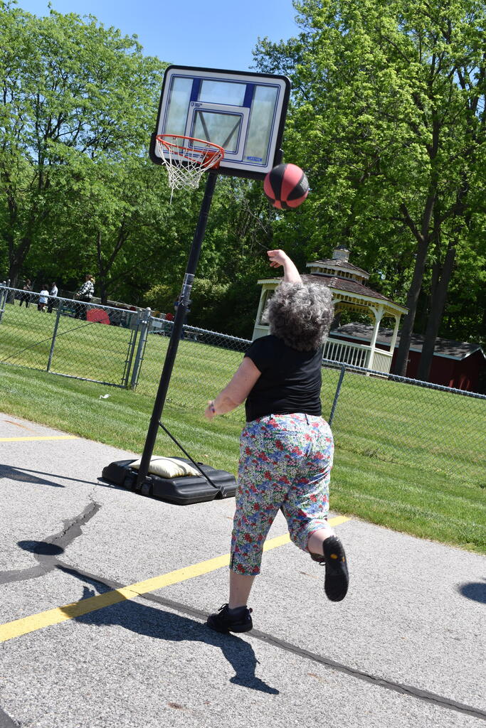 A teacher taking a shot at basketball