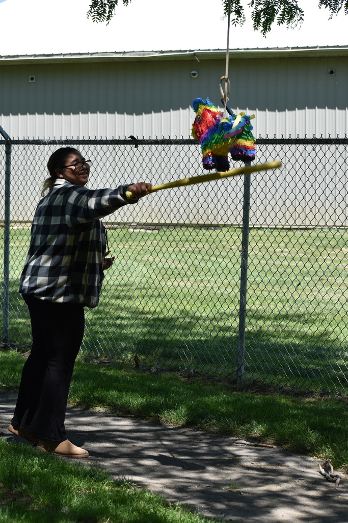 A student taking a swing at a pinata