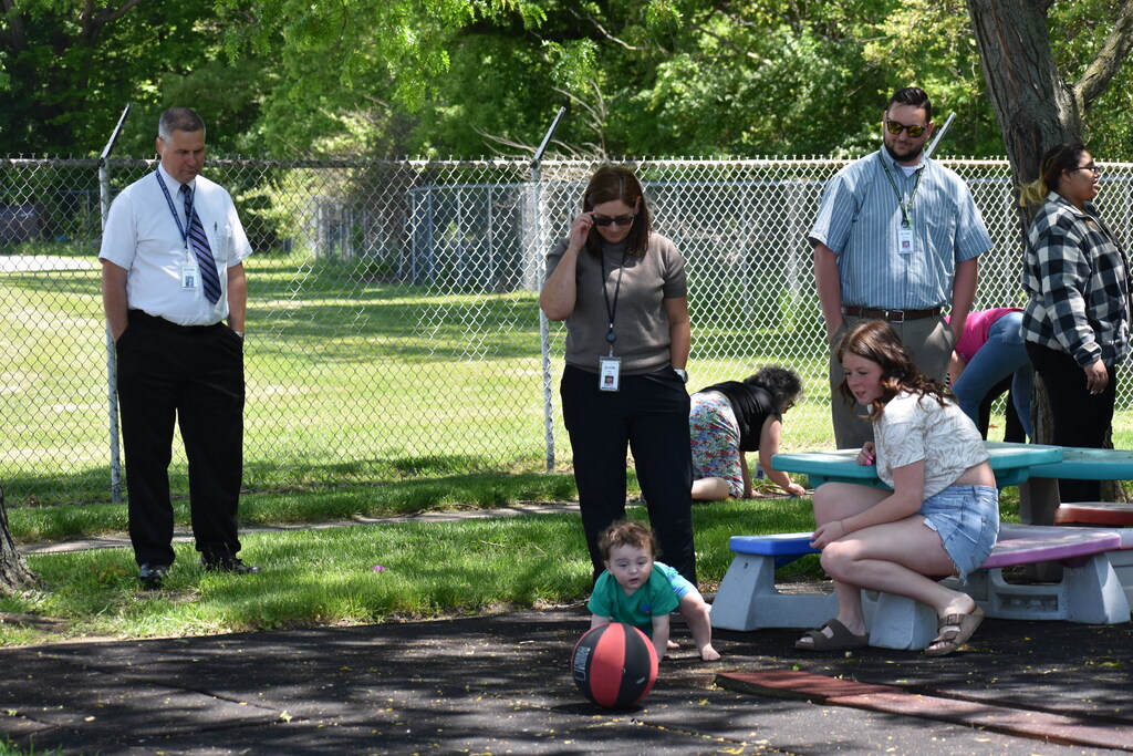 Students and staff handing out around a picnic table