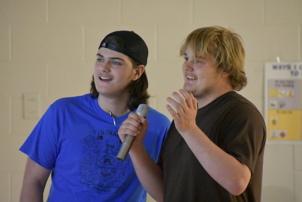 Two students singing a song together