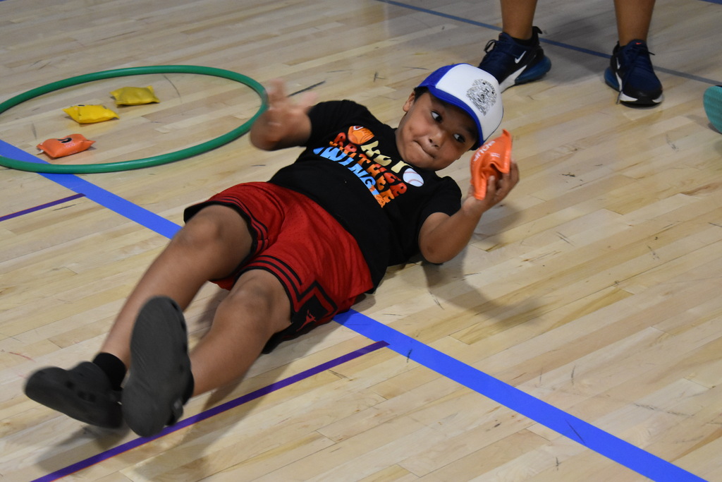 A student rolling on the ground during a game