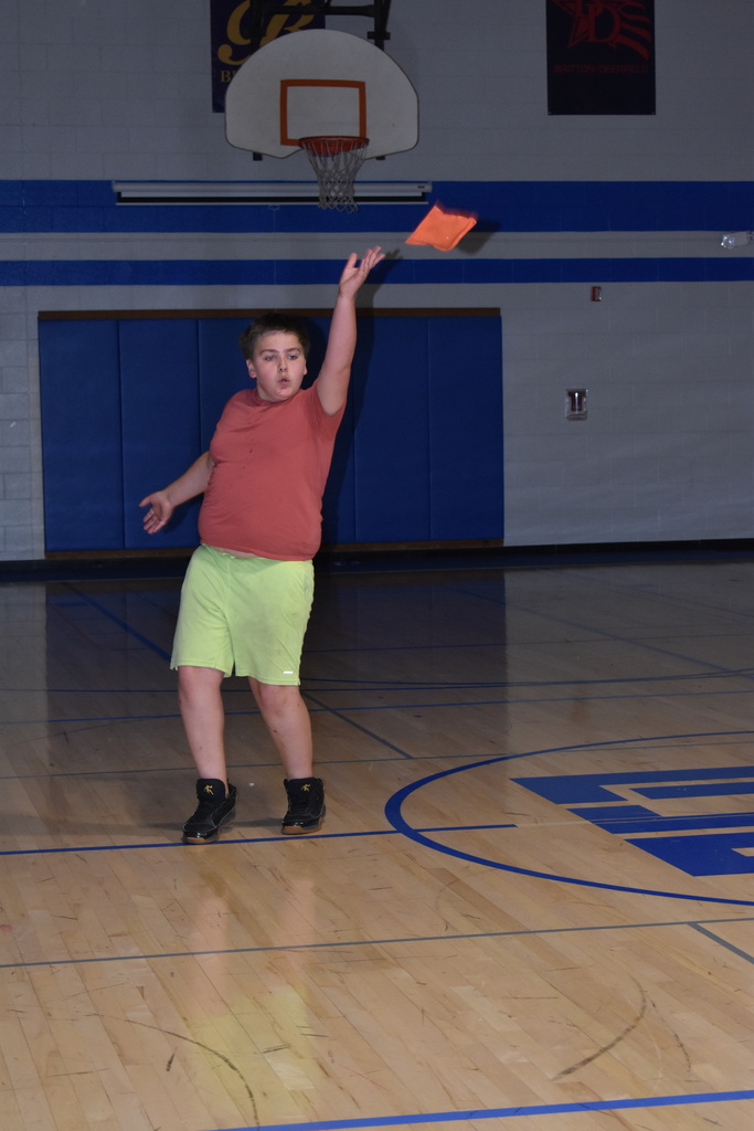 A student tossing a bean bag