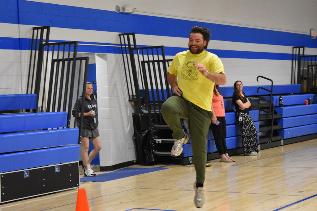 A teacher skipping during a relay at Porter
