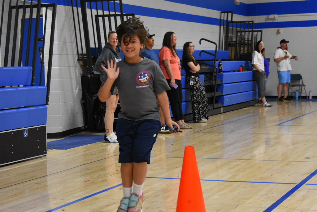A student hopping during a game in the gym at Porter