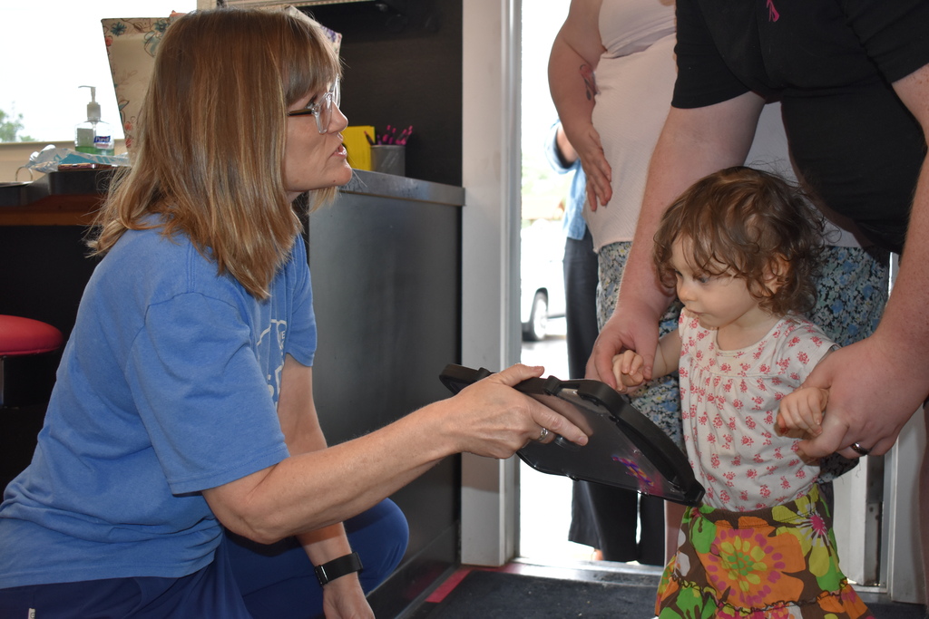 LISD employee and a child using an AAC Device to order ice cream