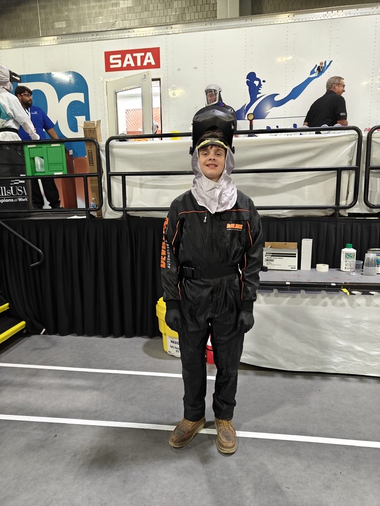 A student in his competition safety gear posing for a photo