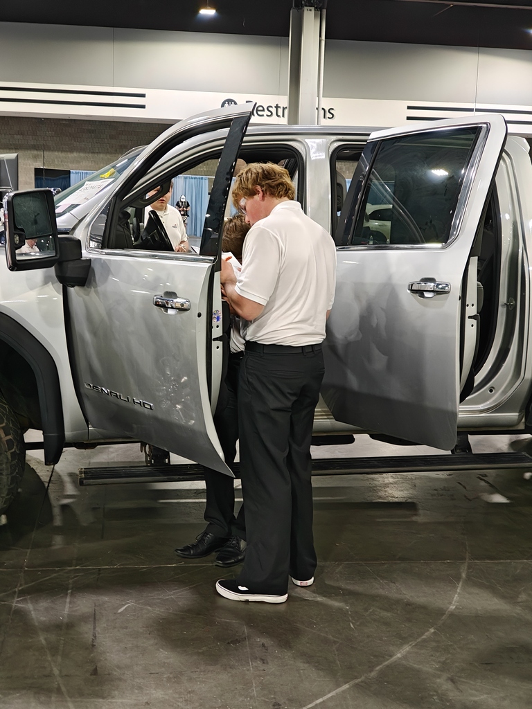 A student on the competition floor working on a truck