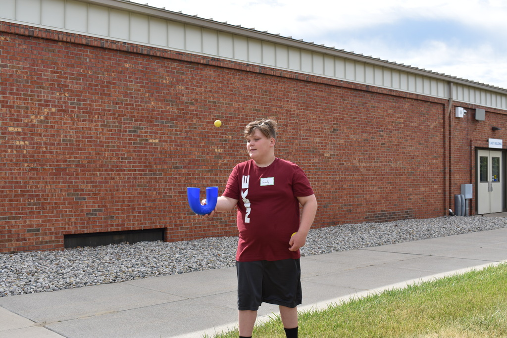 A student demonstrating a ball activity during break at camp