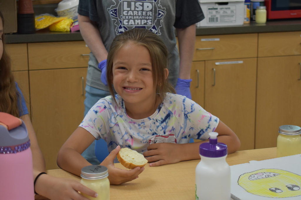 A girl trying her bread and butter