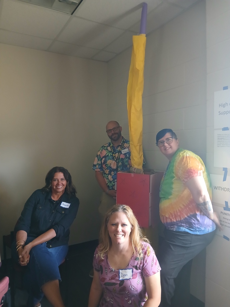 Four LISD employees working on a team building exercise together