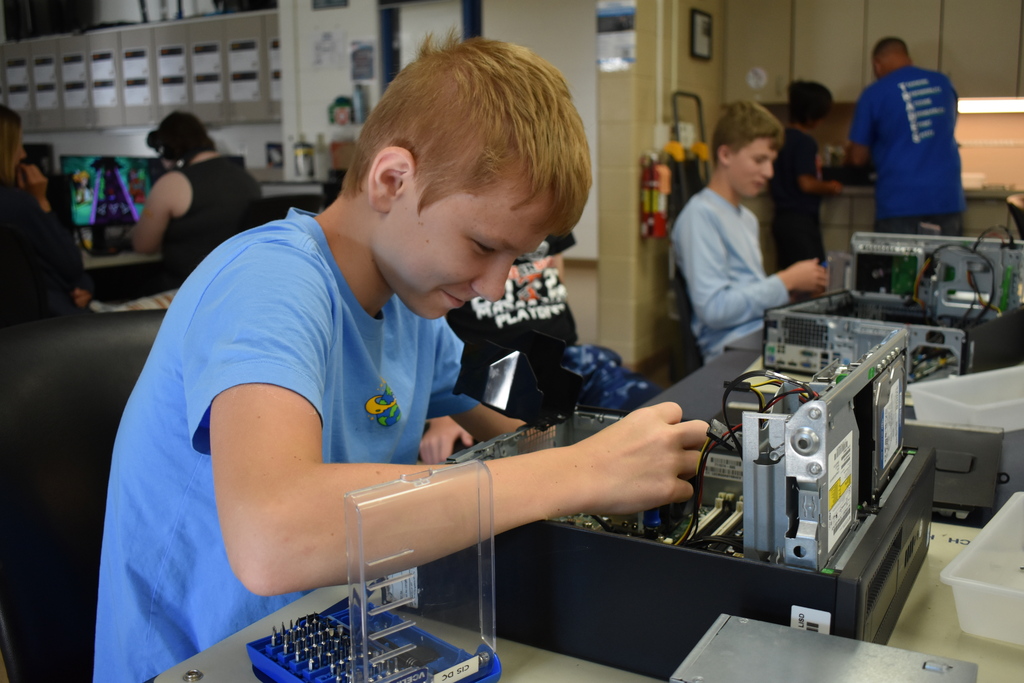 A student taking apart a PC