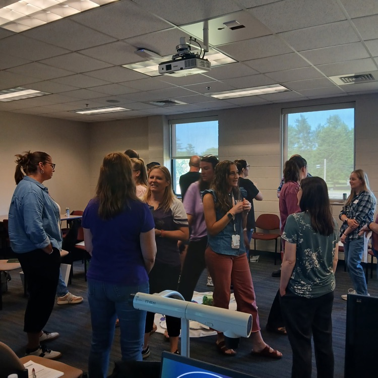 participants standing around a room talking to each other