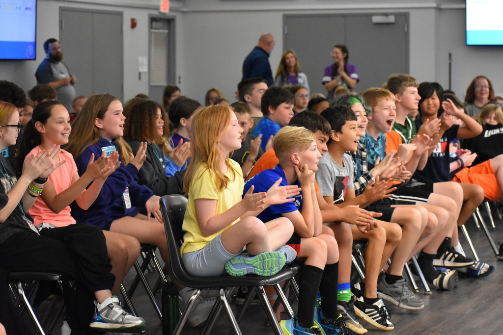 A group audience shot of the kids celebrating their teammate