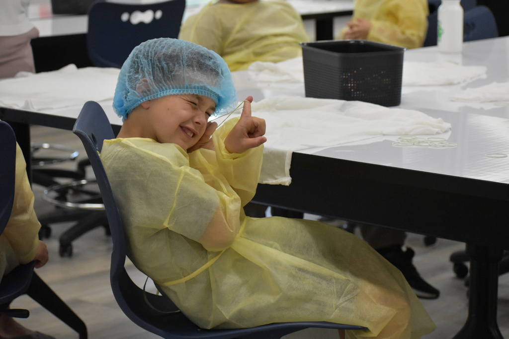 A kid eyeing a rubber band sling shot